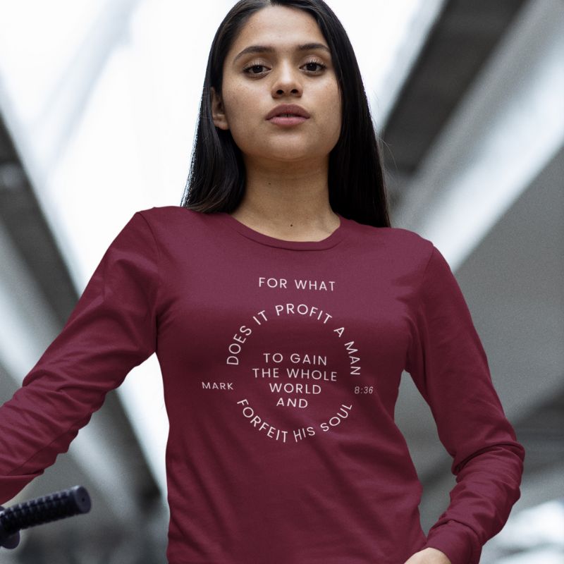 Hispanic woman wearing a maroon long sleeve shirt that says "For what does it profit a man to gain the whole world and forfeit his soul - Mark 8:36"
This shirt is sold at Amela&