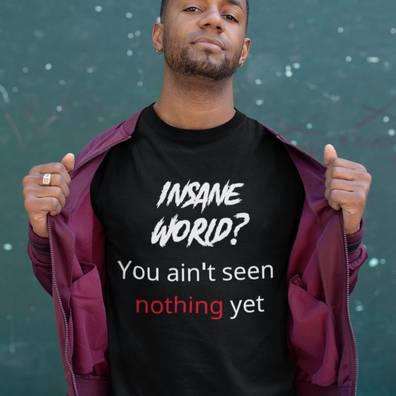 Black man wearing black t-shirt shirt that says "Insane world? You aint seen nothing yet" the shirt is from Amela&