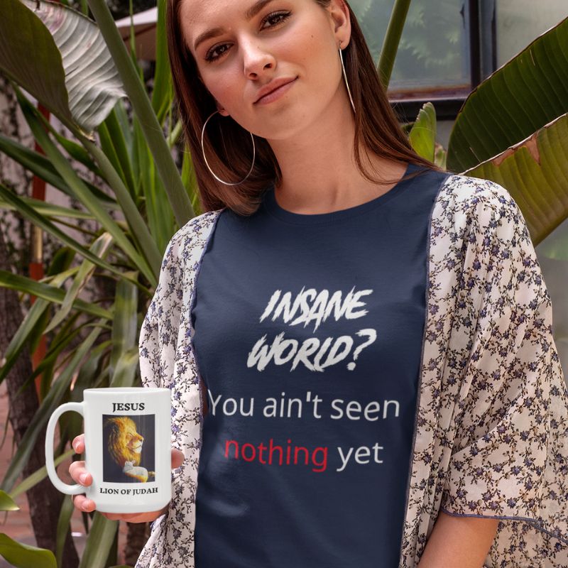 White woman wearing navy t-shirt shirt that says "Insane world? You aint seen nothing yet" the shirt is from Amela&