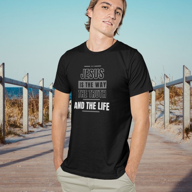 White man wearing a black Christian unisex t-shirt that says in big bold lettering:
"JESUS IS THE WAY, THE TRUTH, AND THE LIFE"