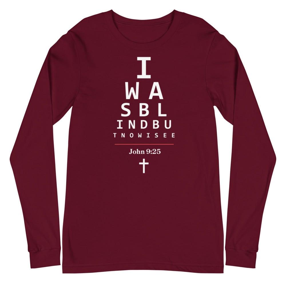 Flatlay of a long-sleeve maroon Christian shirt.
The graphic is text as an eye chart, and it says "I WAS BLIND BUT NOW I SEE".
Below the text, there is a thin line, with text "John 9:25" and an icon of a cross below.
