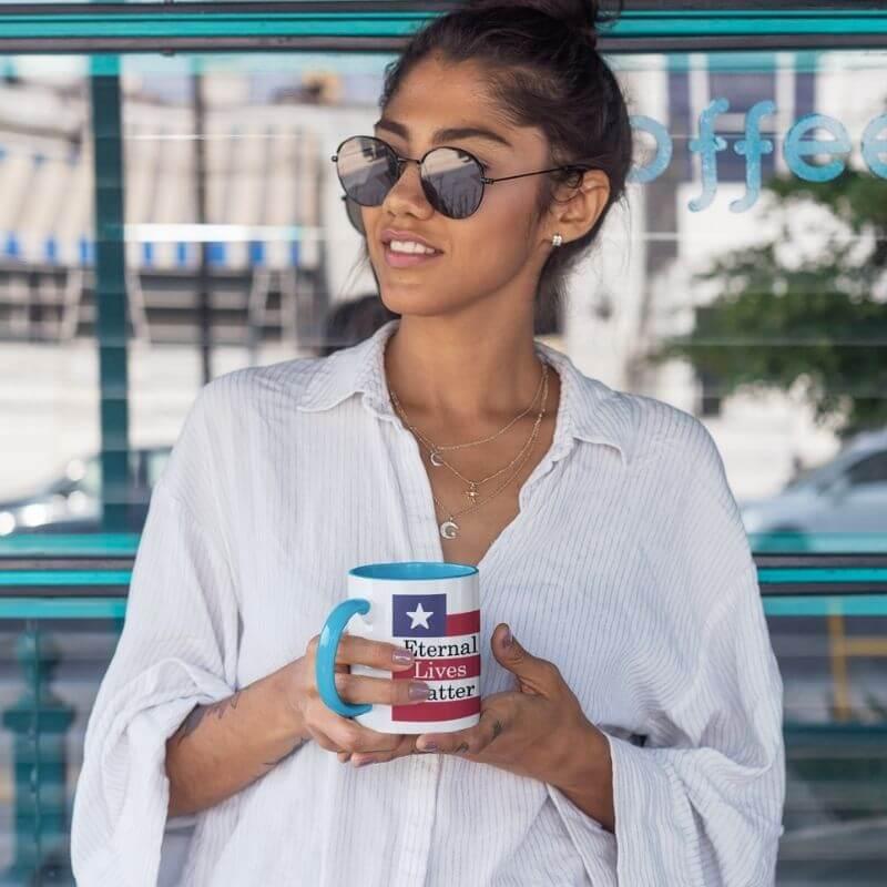 Female holding mug with Christian message