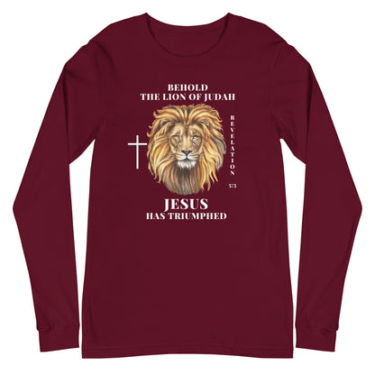 Flatlay of a maroon Christian long-sleeve shirt that says &quot;Behold the lion of Judah&quot;. Below the text, there is a graphic of a lion, with a cross icon next to it, and &quot;Revelation 5:5&quot;. On the bottom, text says &quot;JESUS has triumphed&quot;